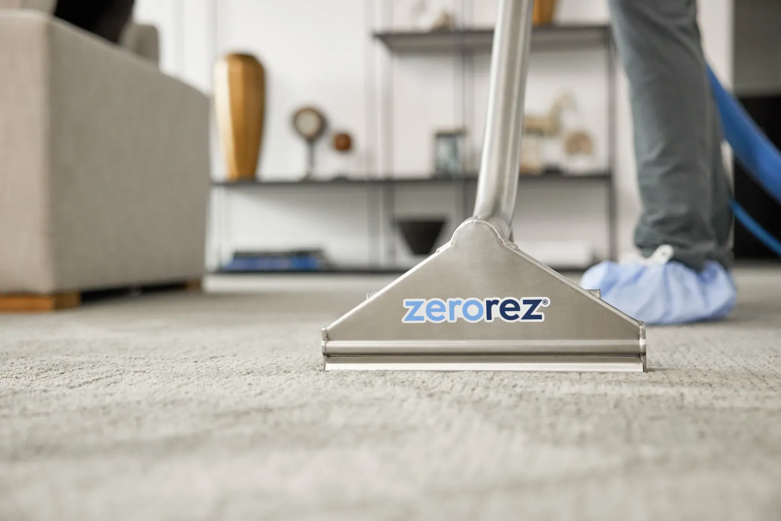 carpet cleaning wand on gray carpet